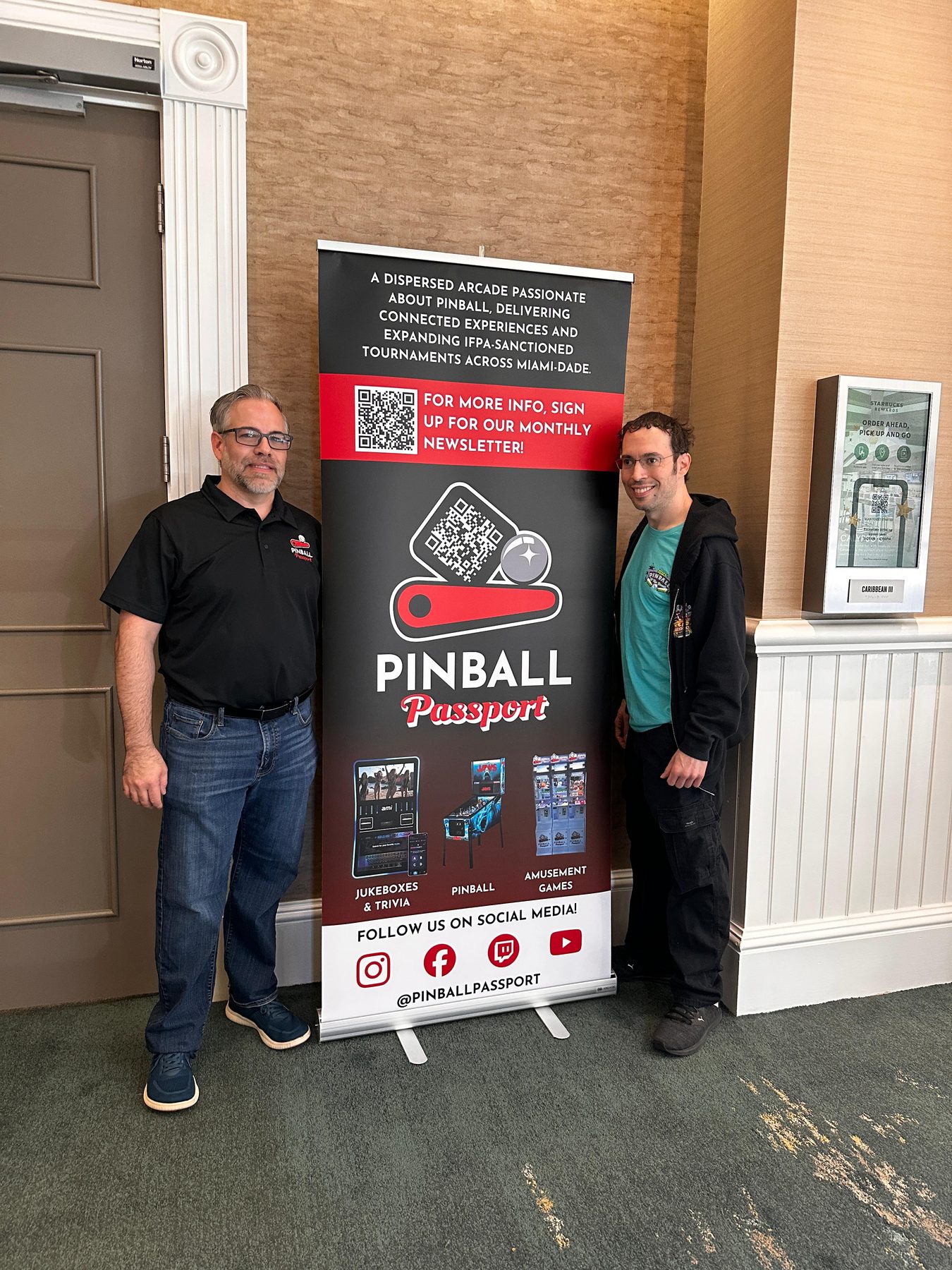 Eric Rodriguez with Pinball Passport signage